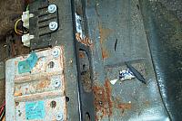 Spot rust damage on floor by seat mount